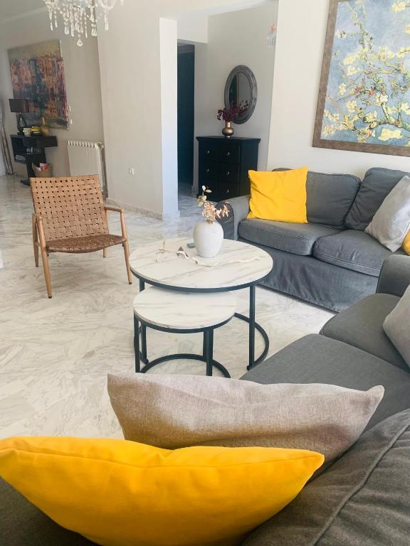 a living room with a couch and a table at Christos House in Afantou