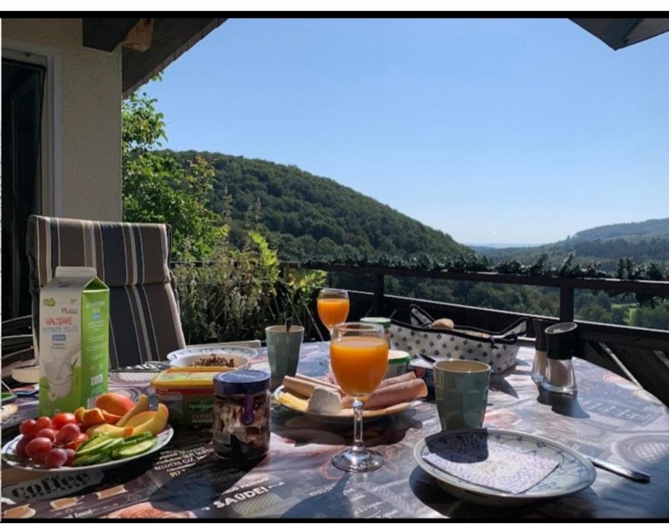 a table with food and drinks on top of a balcony at Ferienwohnung zum Märchenwald in Bergfreiheit