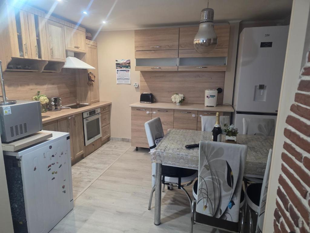 a kitchen with a table and chairs in a room at Къща Теяна in Tryavna