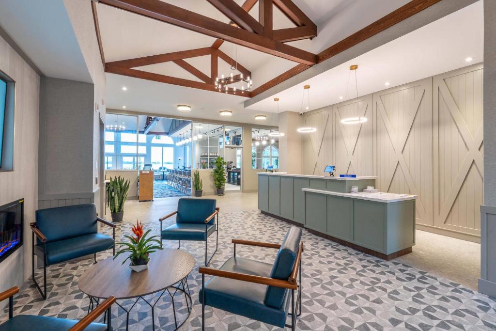 an office lobby with blue chairs and a table at Isaiah Tubbs Resort & Conference Centre in Picton