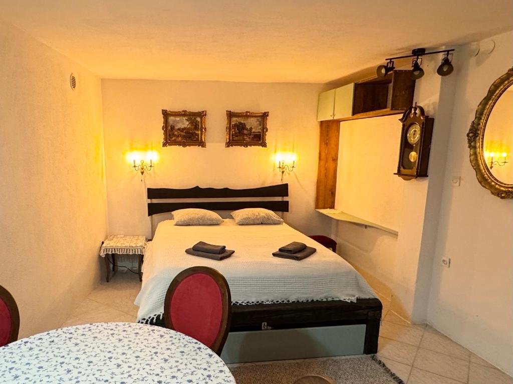 a bedroom with a bed with two towels on it at 'Round the Corner in Piran