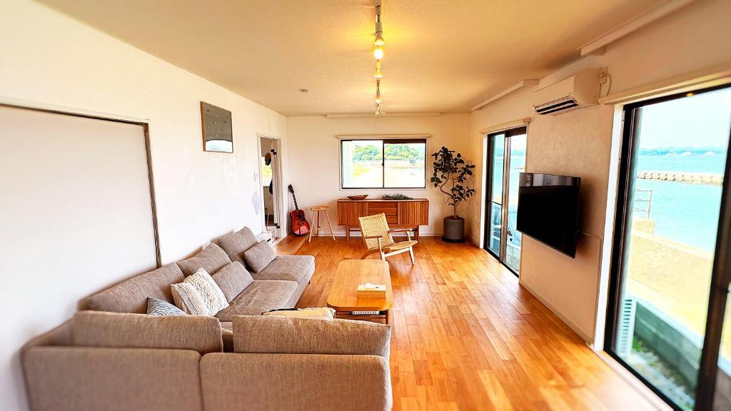 a living room with a couch and a table at Ocean view JUN in Shima