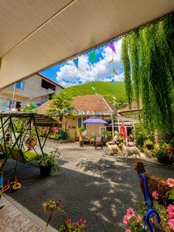 a view of a garden with dogs walking around at Sheki Secret Garden Boutique Hotel & Guest House in Sheki