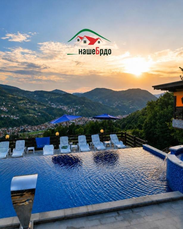 a swimming pool on the roof of a house with the sunset at STD Bešević "Naše Brdo" Ivanjica in Ivanjica