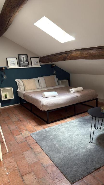 a bedroom with a large bed in a attic at Appartamento centro parma con ascensore BORGO 22 in Parma
