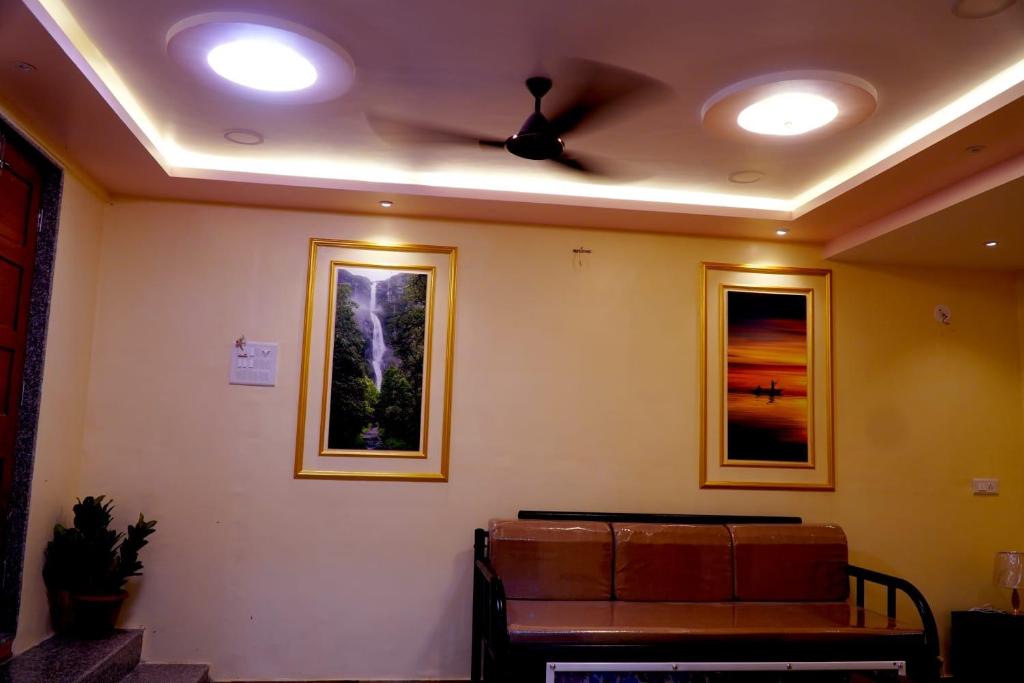 a living room with a ceiling fan and a couch at Sitara Homestay in Ratnagiri