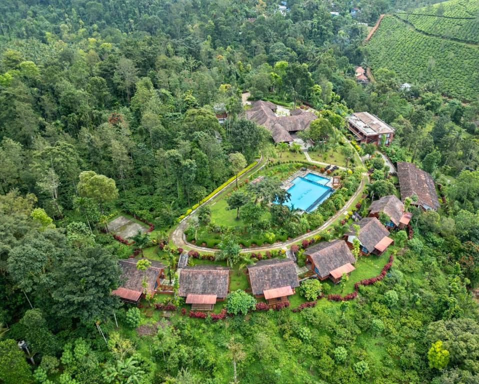 an aerial view of a resort with a pool at Pranavam Resort & Spa in Padinjarathara