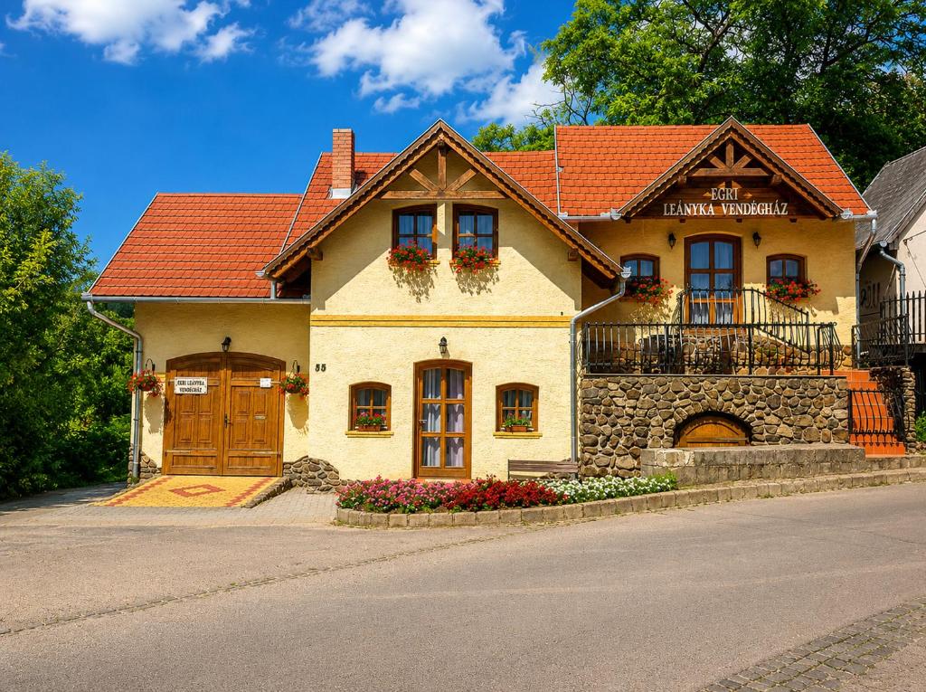 a large yellow house with a red roof at Egri Leányka Vendégház in Eger