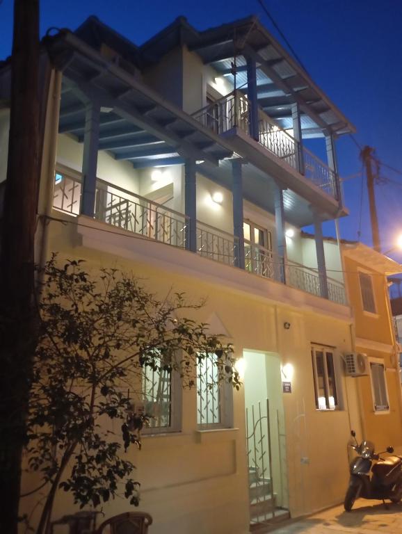 a house with a balcony at night at LocArt room3 in Lefkada