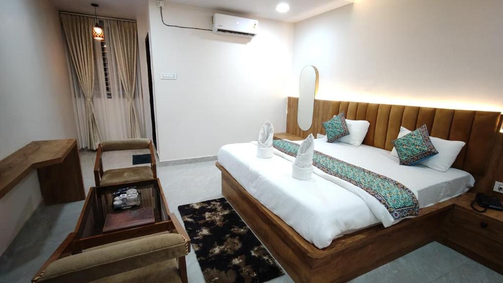 a bedroom with a large bed in a room at hotel shivam comfort in Dhārwād