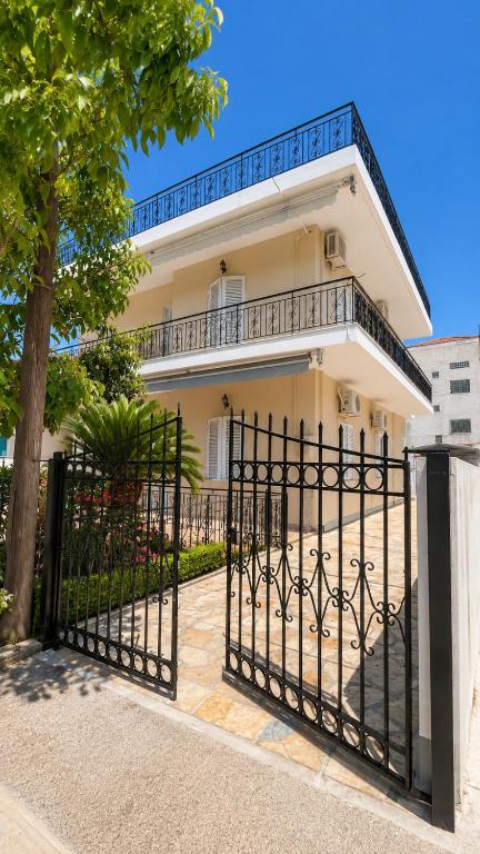 an iron gate in front of a house at Hemithea Nidri Rooms in Nydri