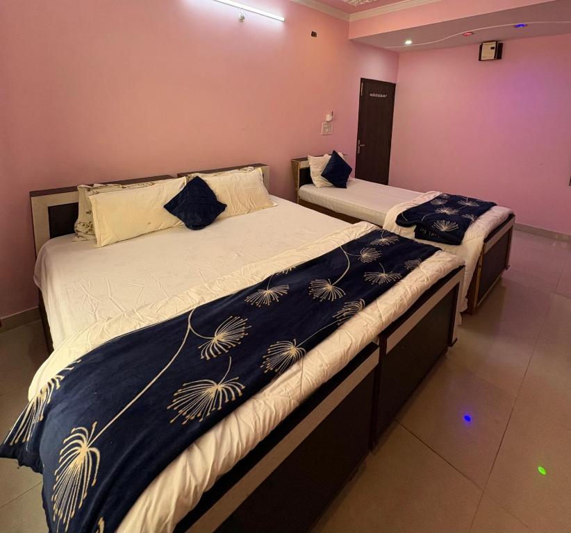 two twin beds in a room with at Pine View Guest House in Nāhan