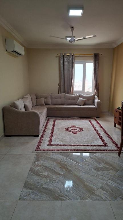 a living room with a couch and a rug at حياة النعيم in Salalah
