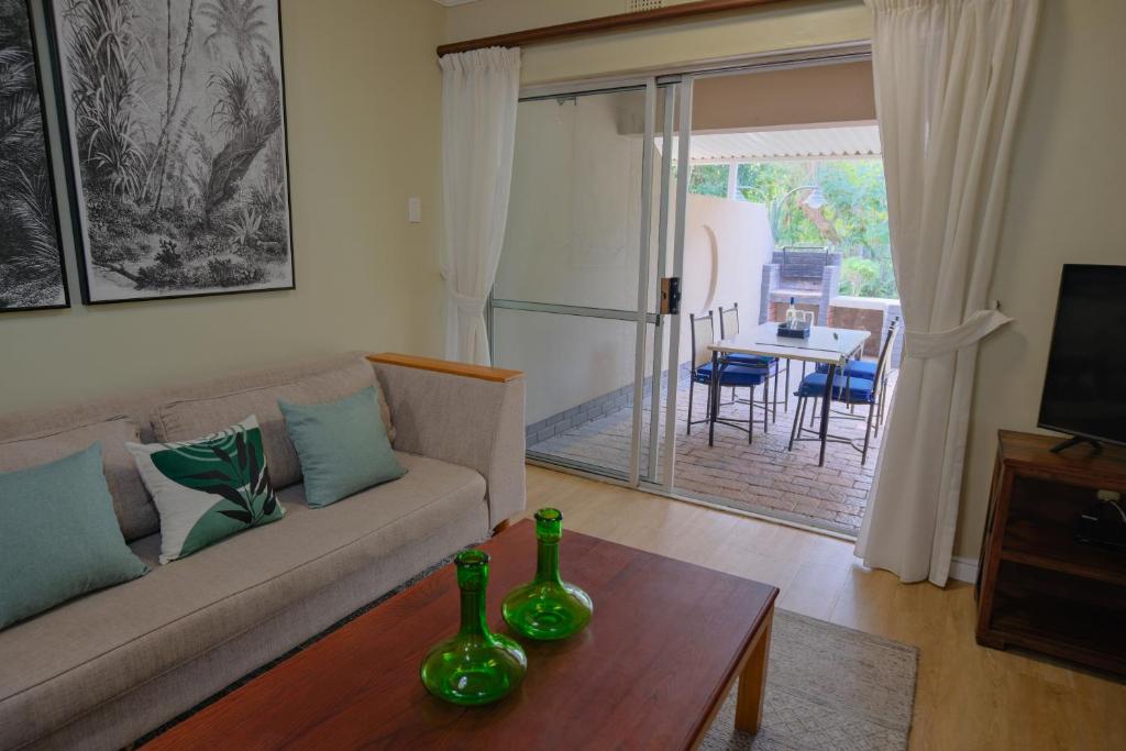 a living room with a couch and a table at Lakeview Cabanas - Unit 5 in St Lucia