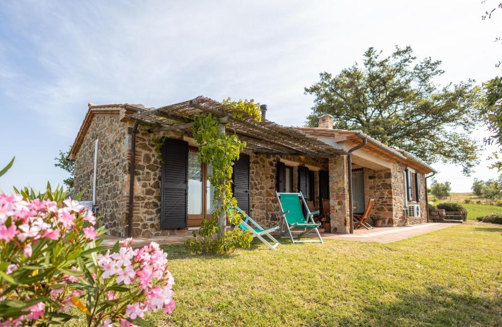 a stone cottage with a garden in front of it at La Casina dei Lapi in Catabbio