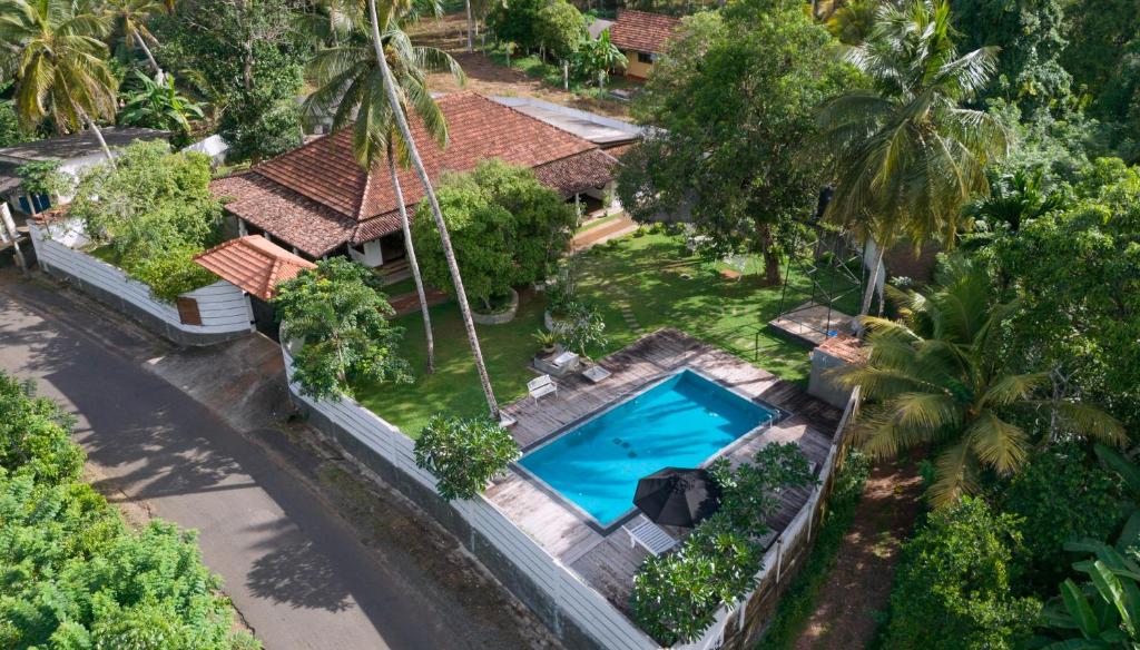 an overhead view of a house with a swimming pool at Echoing Dream Resort in Galle