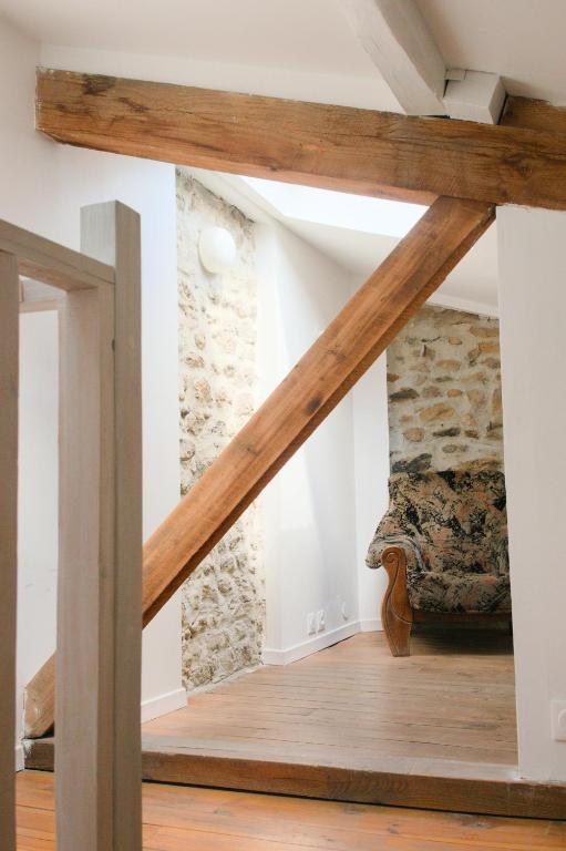 a staircase in a room with wooden beams at Maison Entière à Cébazat in Cébazat