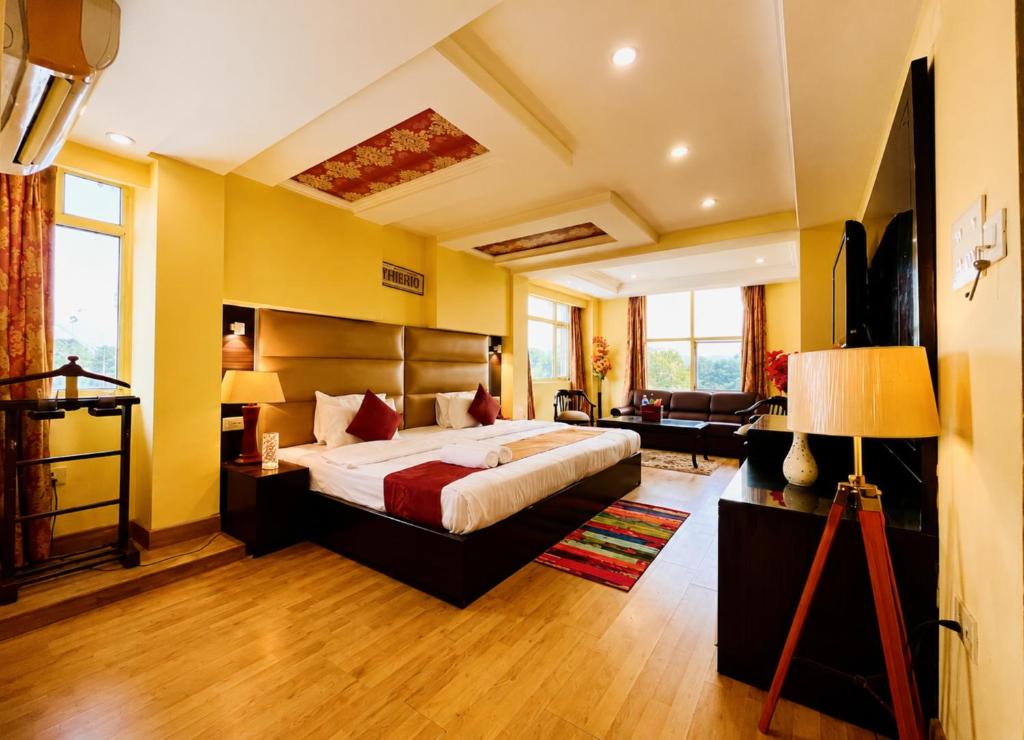a bedroom with a large bed in a room at Hotel Rio Haridwar in Haridwār