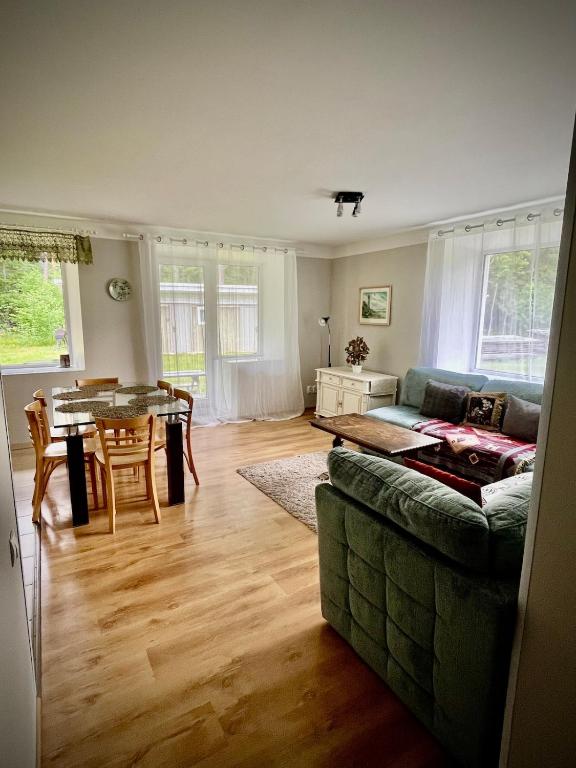 a living room with a couch and a table at Vormsi Ohvitseride Maja korter nr 2 in Hullo