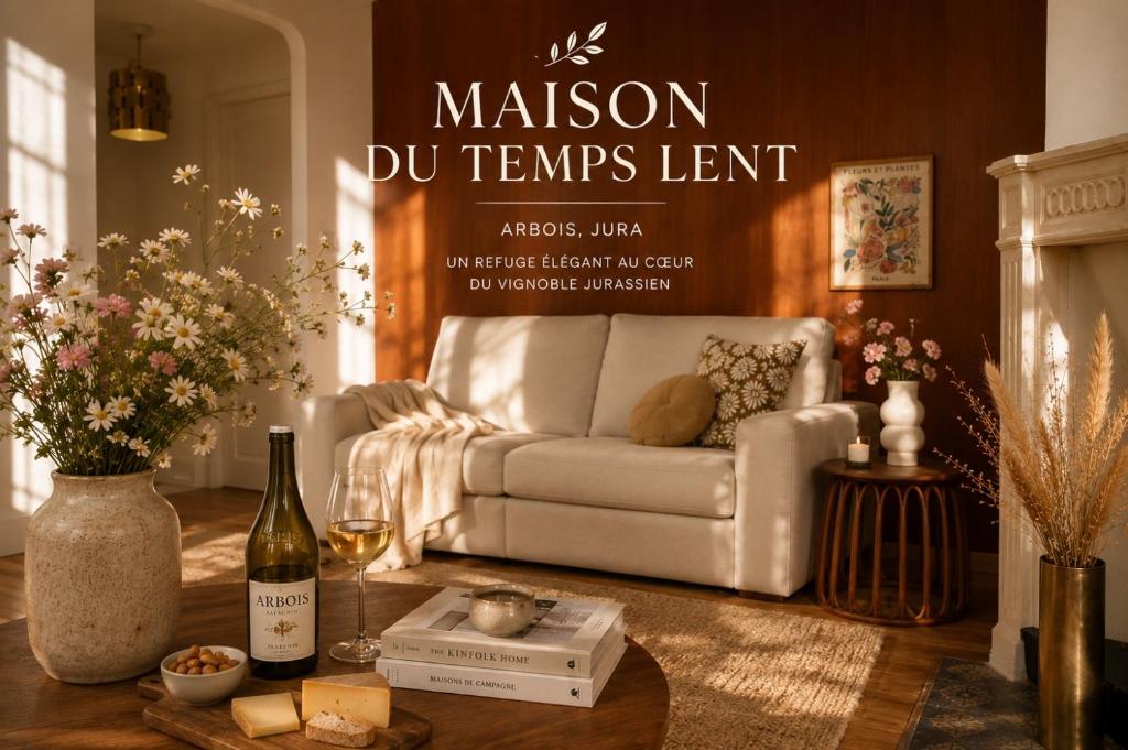 a living room with a couch and a bottle of wine at Maison du temps lent Centre historique en Arbois Escapade Romantique in Arbois