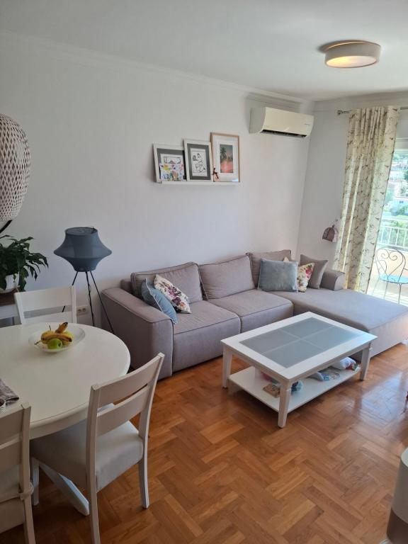a living room with a couch and a table at Aska Apartment in Bar