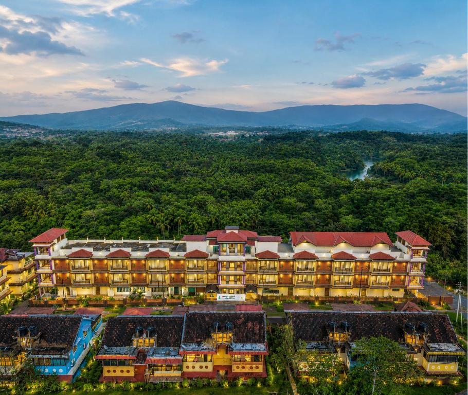 an aerial view of a resort with mountains in the background at Nature Trails Rock Valley, Goa in Ponda