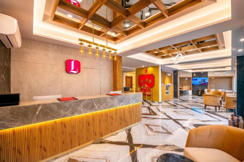 a lobby of a hotel with a bar and chairs at Lords Inn Katra in Jāmb