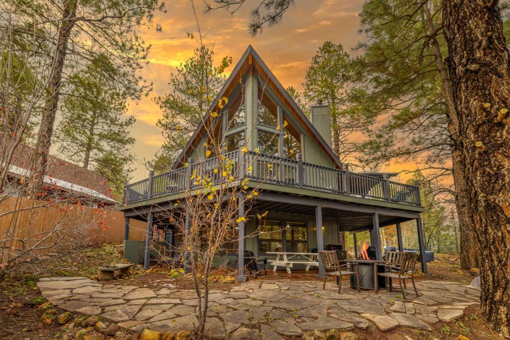 a house with a gambrel roof with a deck at Spacious Flagstaff A-Frame Casita Getaway in Flagstaff