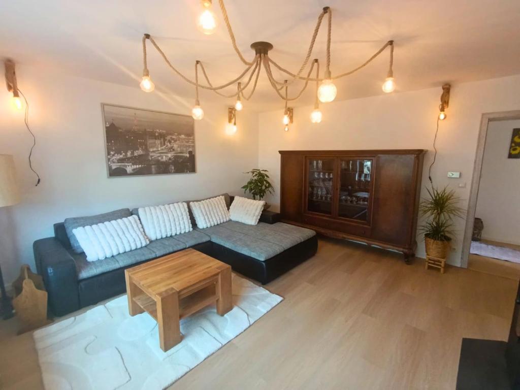 a living room with a couch and a coffee table at EifelRuhe 5 - Platz für bis zu 8 Personen, Hunde willkommen in Schleiden