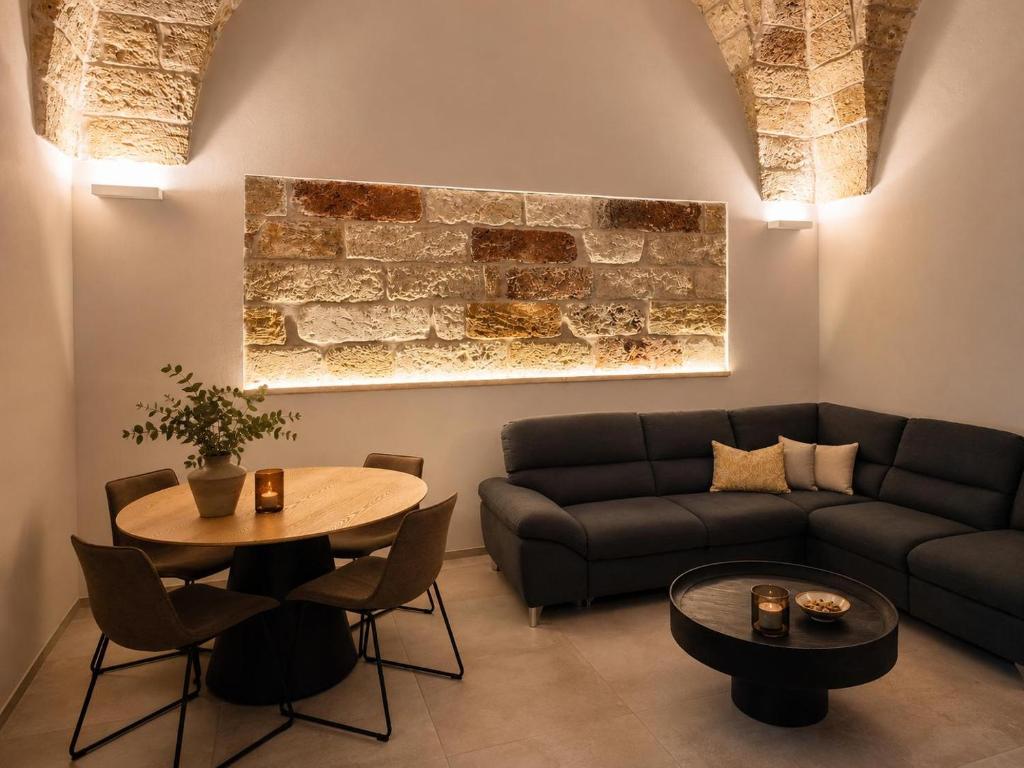 a living room with a couch and a table at L altra Volta in San Pietro Vernotico
