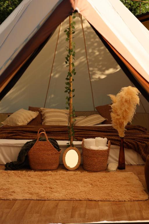 a tent with baskets and other items on a rug at Debed Glamping in Debed
