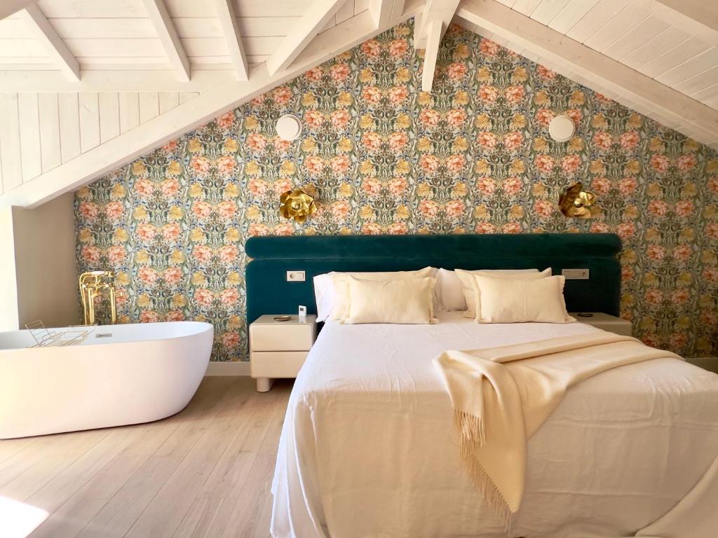 a bedroom with a bed and a bath tub at La Casa de las Flores in Noceda del Bierzo