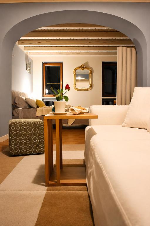 a living room with a bed and a table at Dolomitiloungebelluno Mountain Stay in Belluno