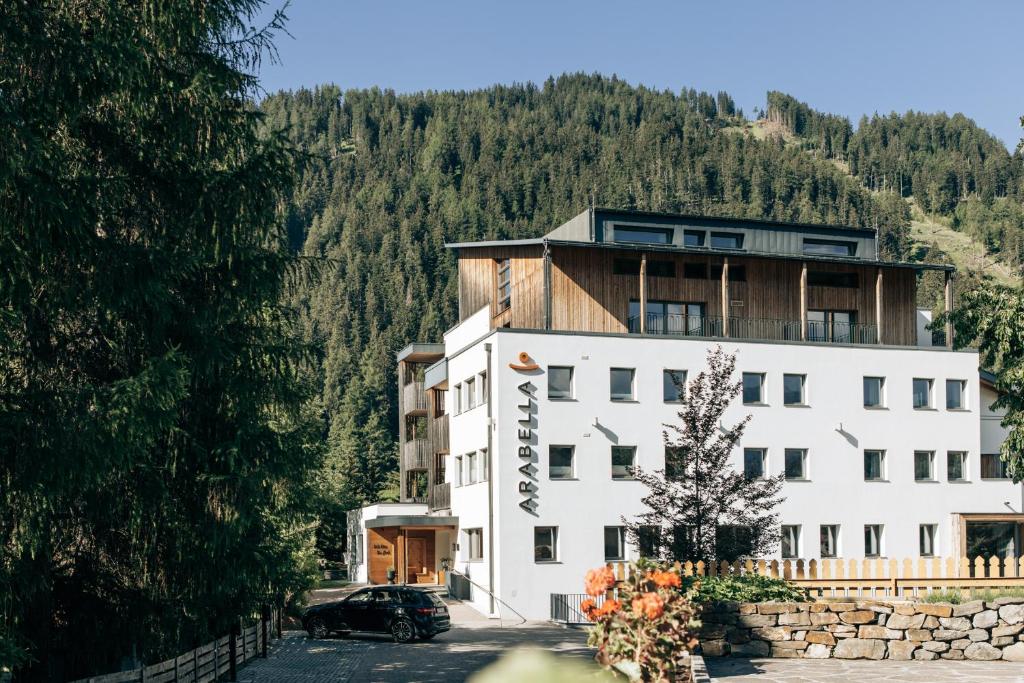 a building with a car parked in front of it at Arabella Retreat & Spa in Nauders