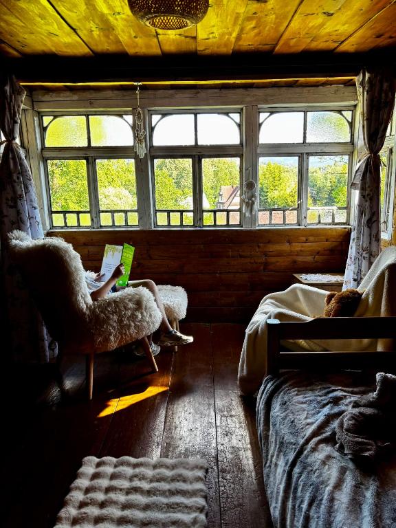 a bedroom with two beds and a window with a laptop at Prociówka in Ciche
