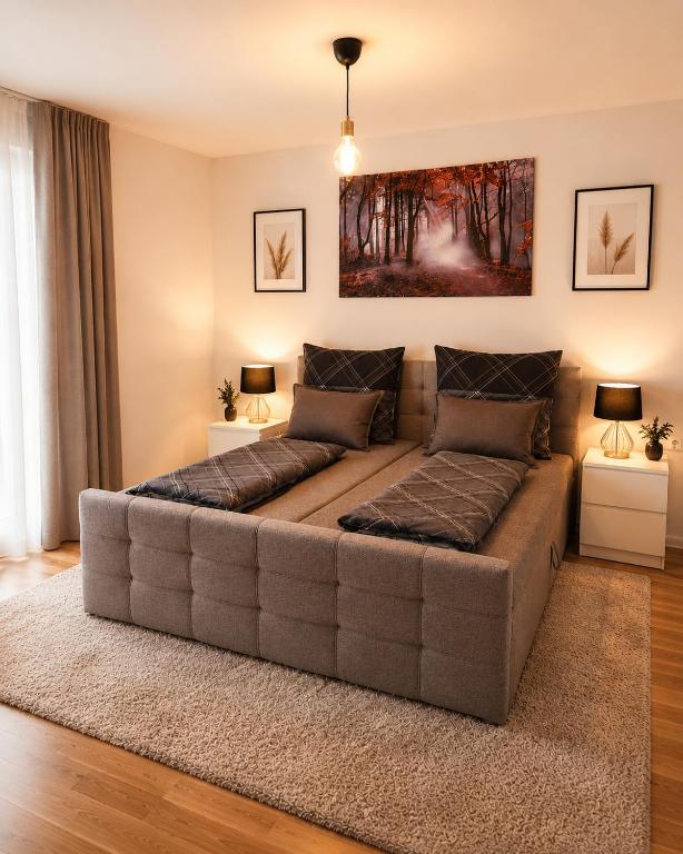 a large couch in a living room with two lamps at Modern Comfort Apartment with Balcony in Dresden