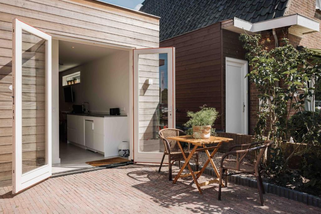an open patio with a table and chairs on a patio at The Dune gate in Zandvoort