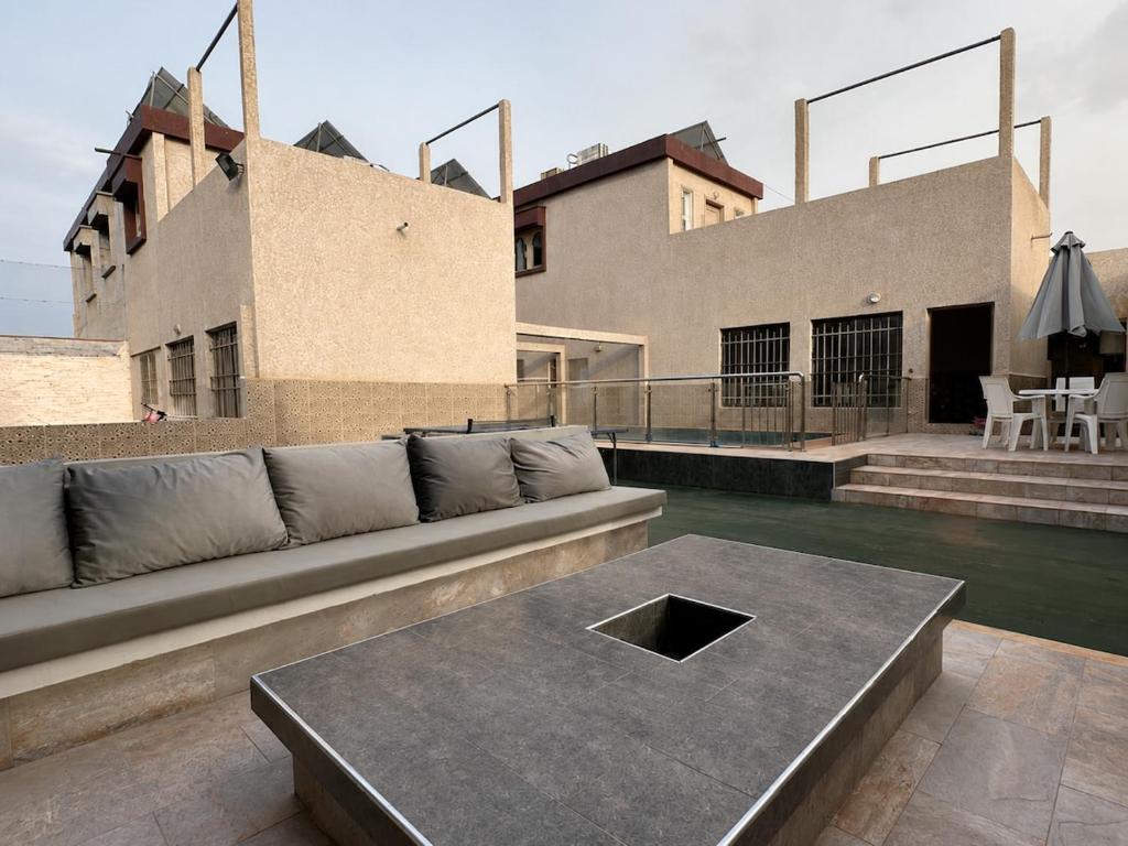 a living room with a couch and a table at Villa privée avec piscine chauffée in Oulad Teïma