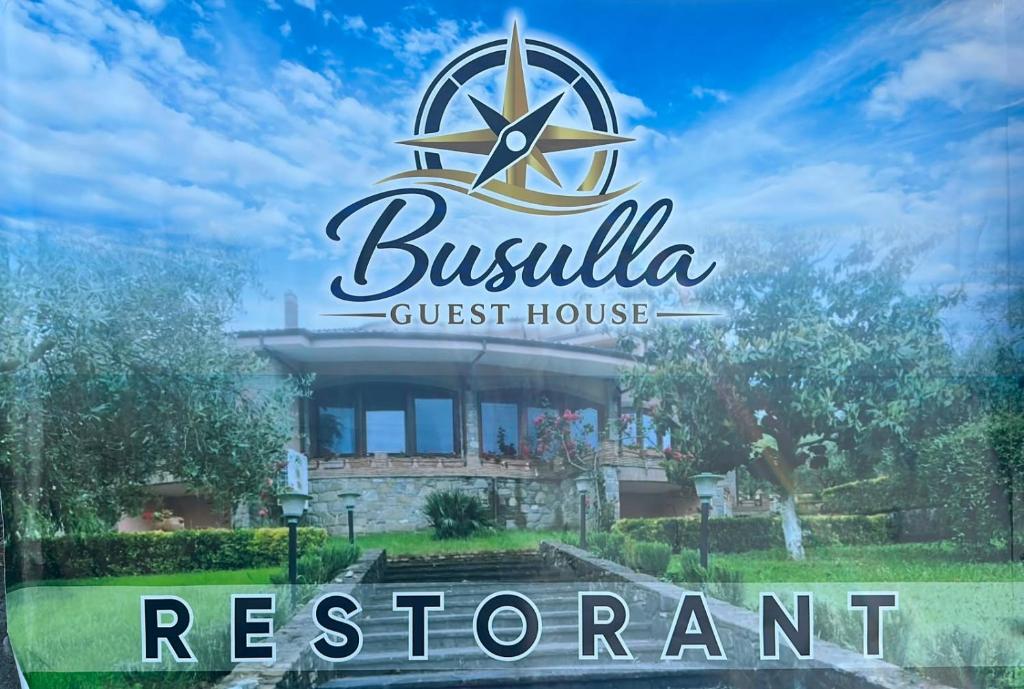 a sign for a guest house in front of a building at Busulla Guest House in Shijak