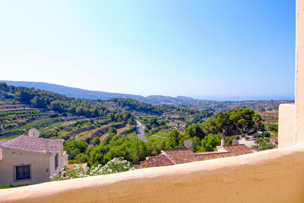 a view from a wall of a village with trees at Casa Morendo in Teulada