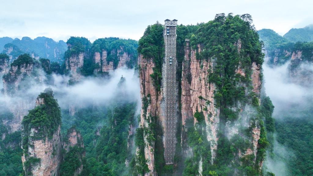 a tallraper on the side of a mountain at Zhangjiajie Cloudscape Villa - New Hotel, Free Private Car Rides to South & East Gates of Zhangjiajie National Forest Park,Free Private Car Rides to & from Airport,Chinese-Western Breakfast, Coffee, Tea & Fruit, Free Laundry & Dryer, Ticket Guidan in Zhangjiajie