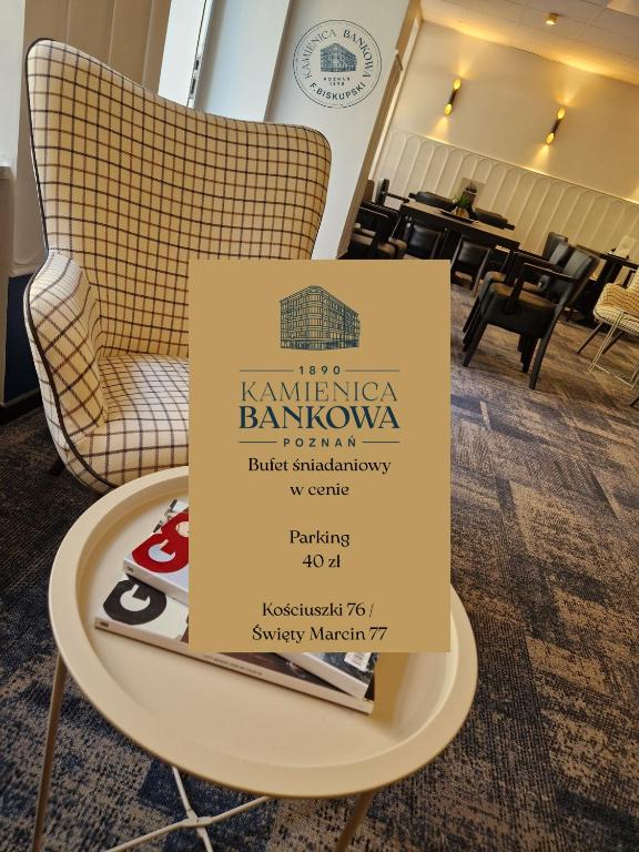 a sign on a table in front of a restaurant at Kamienica Bankowa Residence in Poznań