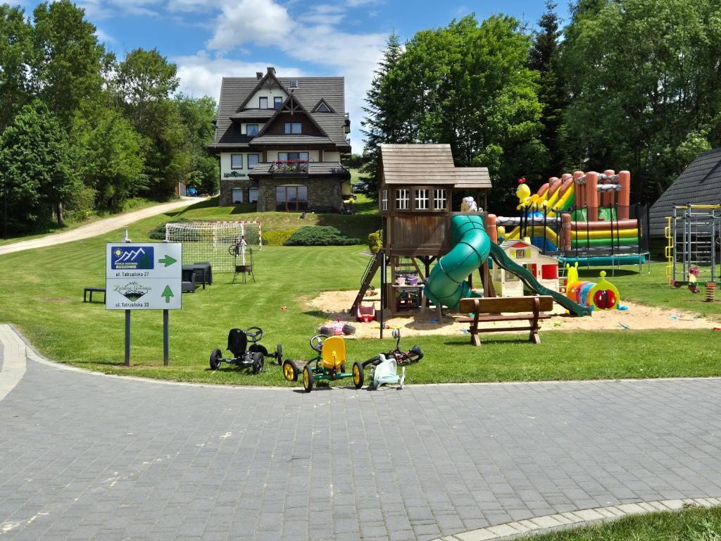 a park with a playground with a slide and play equipment at Willa Zielona Polana in Czarna Góra