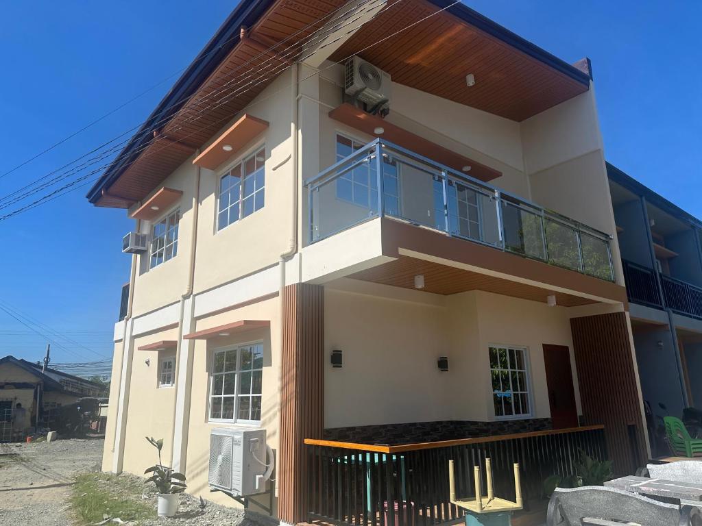 a large white house with a balcony at Casa Gutierrez in Lingayen