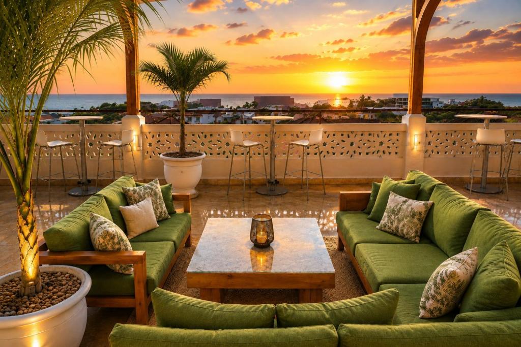 a patio with couches and a table and a sunset at Maji Pearl Hotel & Spa in Nungwi