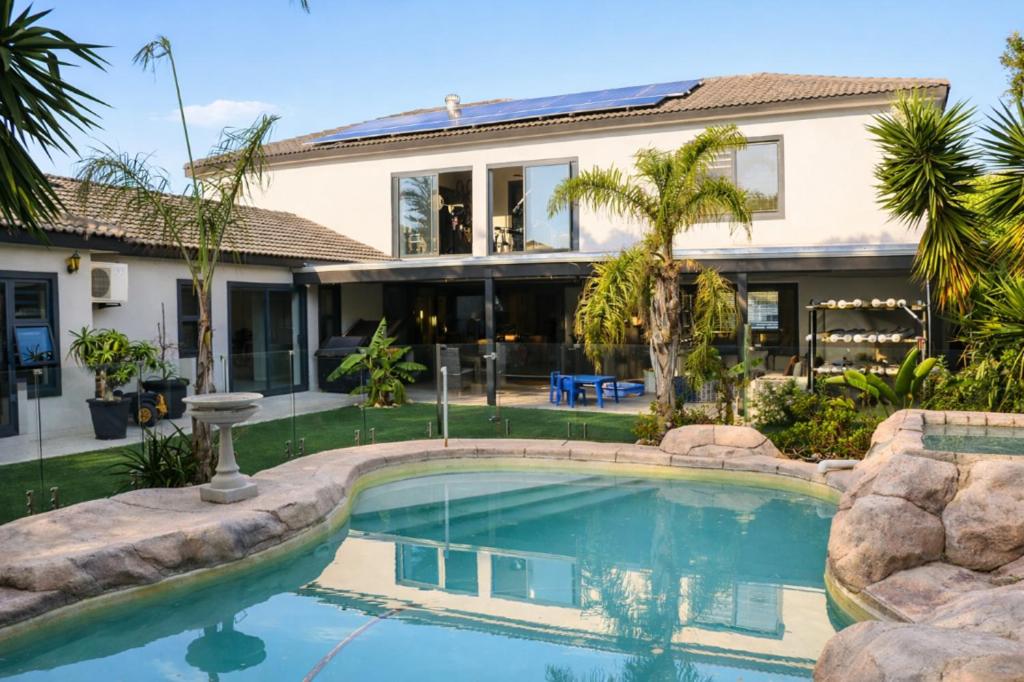 a swimming pool in front of a house at Salt and stone in Cape Town