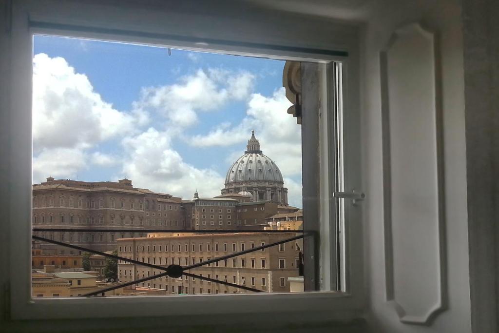 a window with a view of the capitol building at La Rosa del Vaticano Luxury Apartment in Rome