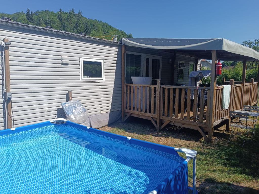 a house with a swimming pool next to a house at Emeraude aux 1000 Etangs in Belonchamp