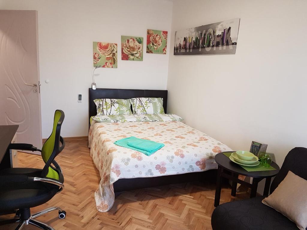 a small bedroom with a bed and a chair at Comfortable Room in The City Centre in Varna City
