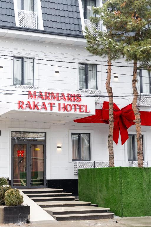 a hotel with a red bow on the front of it at Marmaris Rakat Hotel in Yakkasaray